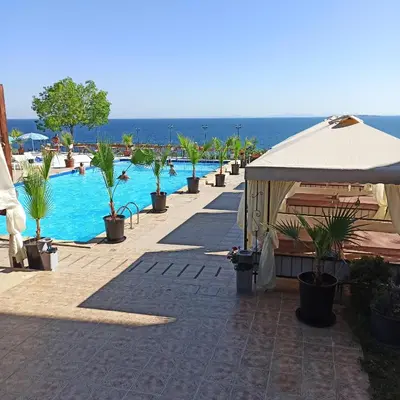 a resort with a swimming pool and an umbrella at Dolce Vita 1 Infinity Love in Sveti Vlas