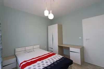 a bedroom with a bed with a red and white blanket at Panoramic Penthouse Apartment in Varna City