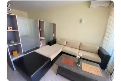 a living room with a couch and a table at Central Beach Apartament in Sunny Beach
