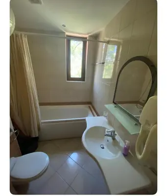 a bathroom with a sink and a tub and a toilet at Central Beach Apartament in Sunny Beach
