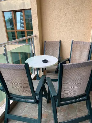 a table and two chairs and a white table and chairs at Central Beach Apartament in Sunny Beach