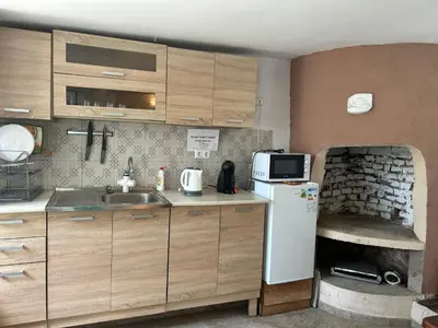 a small kitchen with a sink and a refrigerator at Вила Оазис Сарай - Царево in Tsarevo