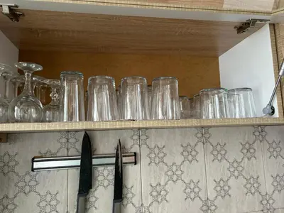 a row of glasses on a shelf in a kitchen at Вила Оазис Сарай - Царево in Tsarevo