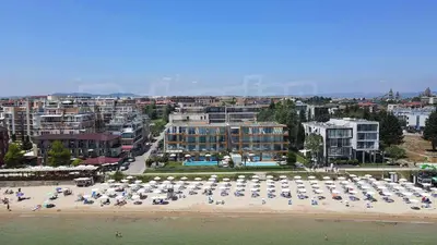 a beach with a lot of umbrellas on the beach at Central Beach Ravda Apartments in Ravda
