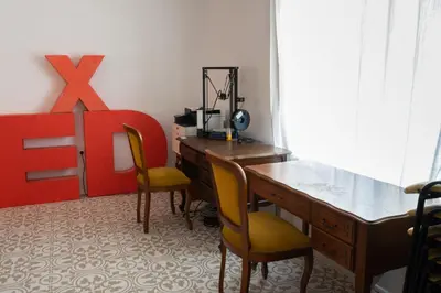 an office with a desk and two chairs in a room at Beehive Hotel and CoWorking in Varna City