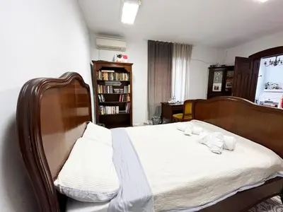 a bedroom with a bed with white sheets and pillows at Beehive Hotel and CoWorking in Varna City