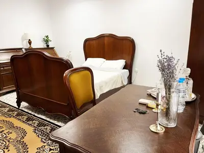 a bedroom with a bed and a wooden table and a table sidx sidx at Beehive Hotel and CoWorking in Varna City