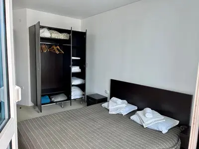 a bedroom with a bed with white pillows on it at Atlantis Resort & 4 swimming pools & Spa & Апартамент in Burgas City