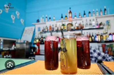 two drinks sitting on a counter in a bar at Atlantis Resort & 4 swimming pools & Spa & Апартамент in Burgas City
