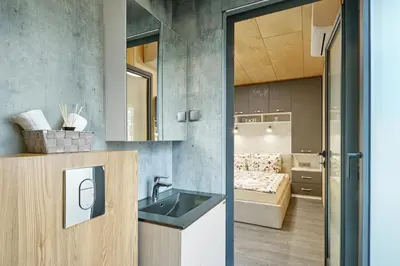 a kitchen with a sink and a bedroom at Holiday Village Smokinia in Sozopol