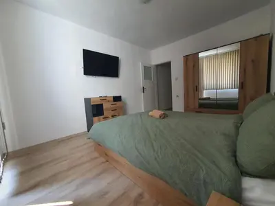 a bedroom with a bed and a flat screen tv at Apartament Lazur 13 in Burgas City