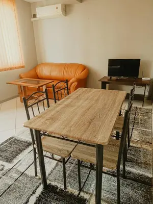 a living room with a table and a couch at Kamelia Garden Apartment in Sunny Beach