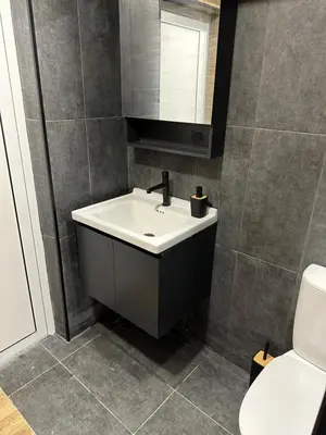a bathroom with a sink and a toilet at Апартамент - Весела улица in Sozopol