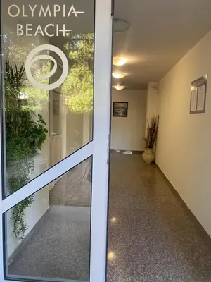 a door to an office with a sign that reads olympia beach at JOY Studio in Ravda
