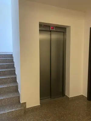 a elevator with an exit sign on the side of a building at JOY Studio in Ravda