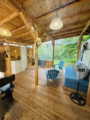 a living room with a wooden ceiling and a piano at Каравана Синята Маймуна плаж Градина # RV Blue Monkey on the beach in Chernomorets