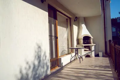 a table sitting on the balcony of a building at Къща за гости Далинда in Byala