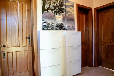 a refrigerator in a room next to a door at Къща за гости Далинда in Byala