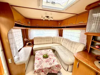 a living room in an rv with a couch and a table at Къмпинг Европа Юг in Burgas City