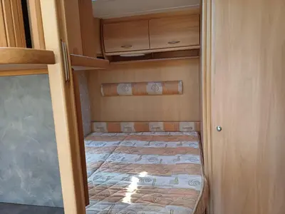 a small bedroom with a bed in a room at Къмпинг Европа Юг in Burgas City