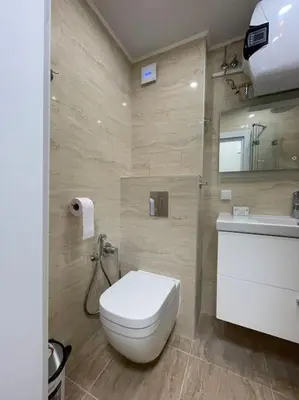 a bathroom with a white toilet and a sink at Comfy home 2 - Burgas Centre in Burgas City