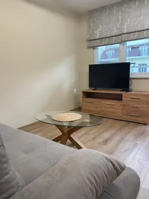 a living room with a tv and a glass table at Comfy home 2 - Burgas Centre in Burgas City