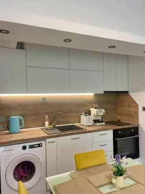 a kitchen with a washing machine and a sink at Varna city Park Apartament in Varna City