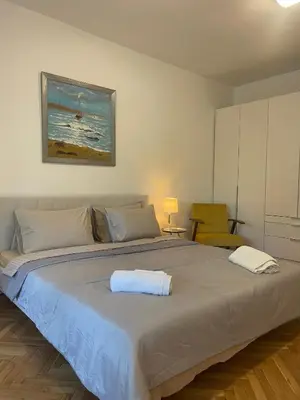 a bedroom with a large bed with two towels on it at Varna city Park Apartament in Varna City