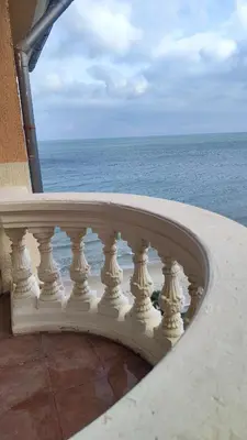 a white railing on a balcony overlooking the ocean at Elenite Sea View Apartments in Elenite