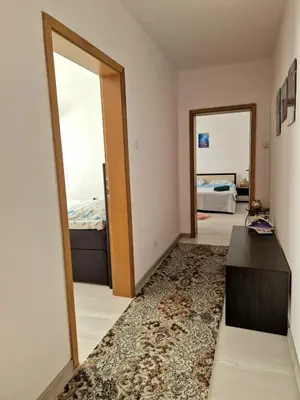 a room with a mirror and a room with two beds at Апартамент Бижу М in Pomorie