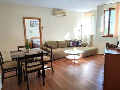 a living room with a couch and a table at Lidda Relax in Oasis Beach Kamchia in Bliznatsi