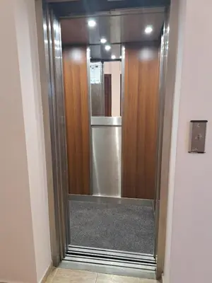 a glass door in a hallway with a refrigerator at Lidda Relax in Oasis Beach Kamchia in Bliznatsi