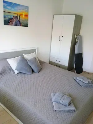 a bedroom with a bed with two pillows on it at Васил Левски 61 in Burgas City