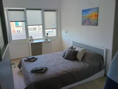 a bedroom with a bed with two pillows on it at Васил Левски 61 in Burgas City