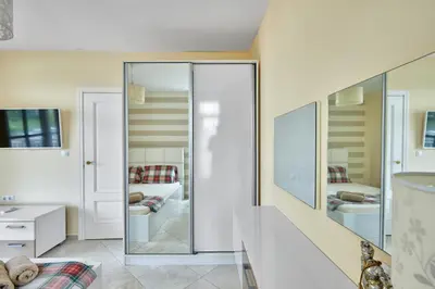 a sliding glass door in a room with a bedroom at 2BD Flat with Balcony in Flores Garden Complex by Flat Mаnаger in Chernomorets