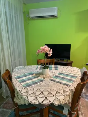 a table with a vase of flowers on top of it at Aurora Sea Breeze in Burgas City