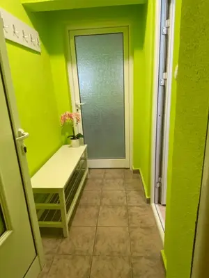 a hallway with a green room with a door at Aurora Sea Breeze in Burgas City