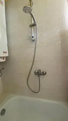 a shower in a bathroom next to a bath tub at Aurora Sea Breeze in Burgas City