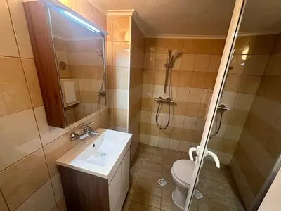 a bathroom with a sink and a shower and a toilet at Studio Lazur in Burgas City