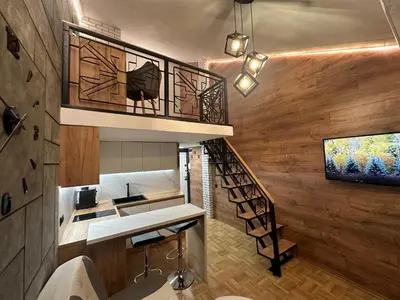 a spiral staircase in a room with wooden walls at Studio Lazur in Burgas City