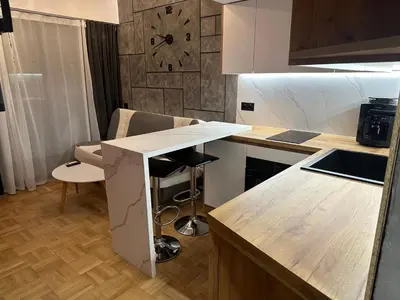 a kitchen with a counter and a clock on the wall at Studio Lazur in Burgas City