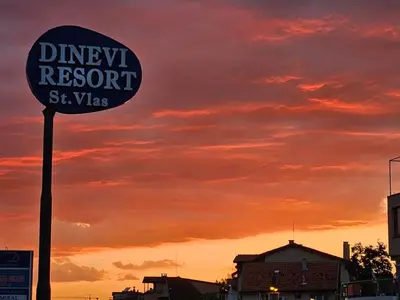 a sign for a disney resort sign in front of a sunset at DELFIN Sea view in Sveti Vlas