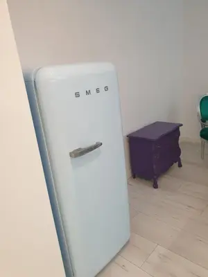 a white refrigerator in a room with a table at BOHO CHIC STUDIO Free parking upon request in Varna City
