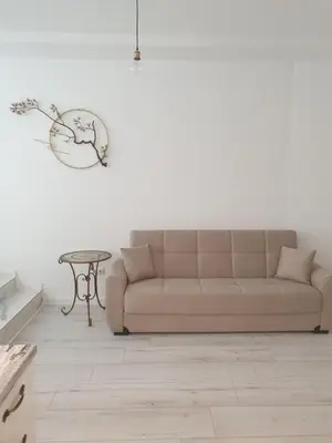 a living room with a couch and a table at BOHO CHIC STUDIO Free parking upon request in Varna City