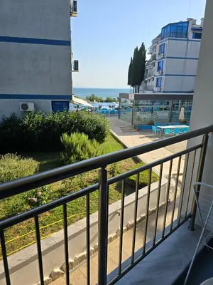a balcony with a view of a beach and a building at POMORIE Luxury Appartment in Pomorie