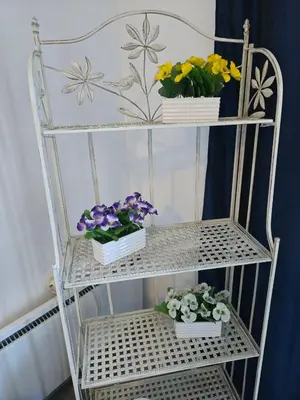 a white shelf with flowers in pots on it at POMORIE Luxury Appartment in Pomorie