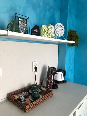 a shelf with a basket on a counter with a tea pot at Студио - Морско бягство in Primorsko