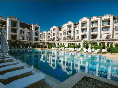 a large swimming pool in front of some buildings at Студио в Затворен Комплекс Blue in Sozopol