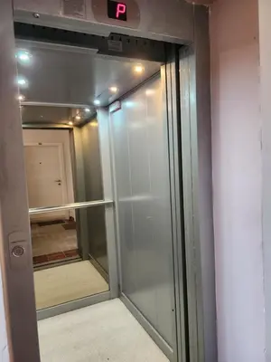 a sliding glass door with a clock on it at Студио в Затворен Комплекс Blue in Sozopol