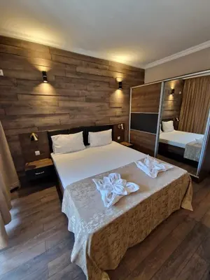 a bedroom with a large bed with a mirror at MitProt Panorama Bay 2 Luks Apartment 110 in Sveti Vlas